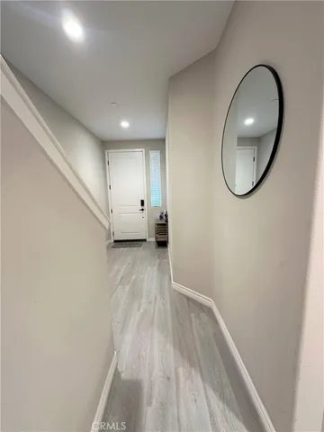 a view of a room with wooden floor and white walls