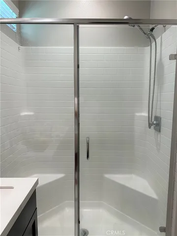 a bathroom with a shower and a bath tub