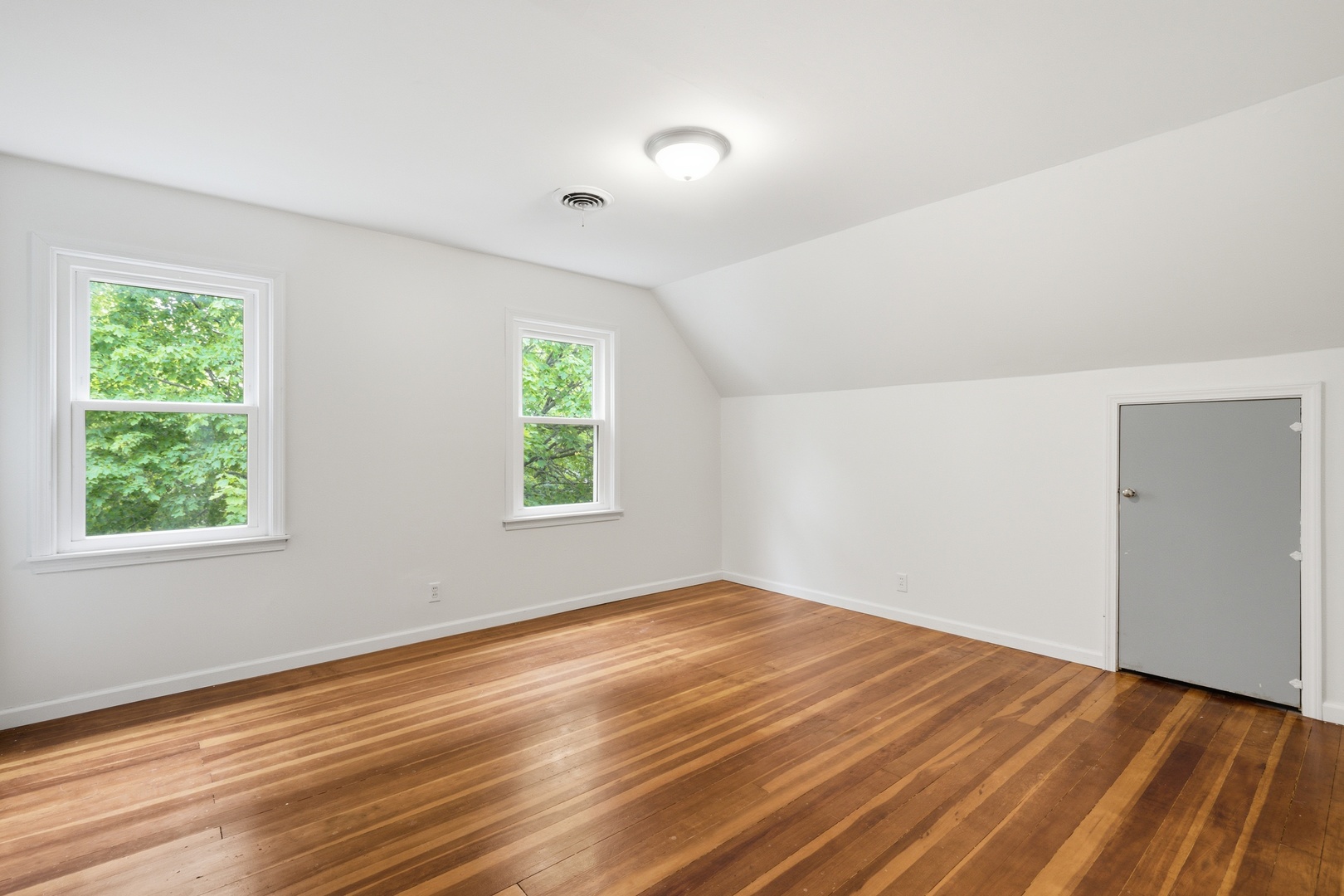 1847 10th Street Moline, IL 61265 - Photo 22 of 39 an empty room with wooden floor and windows