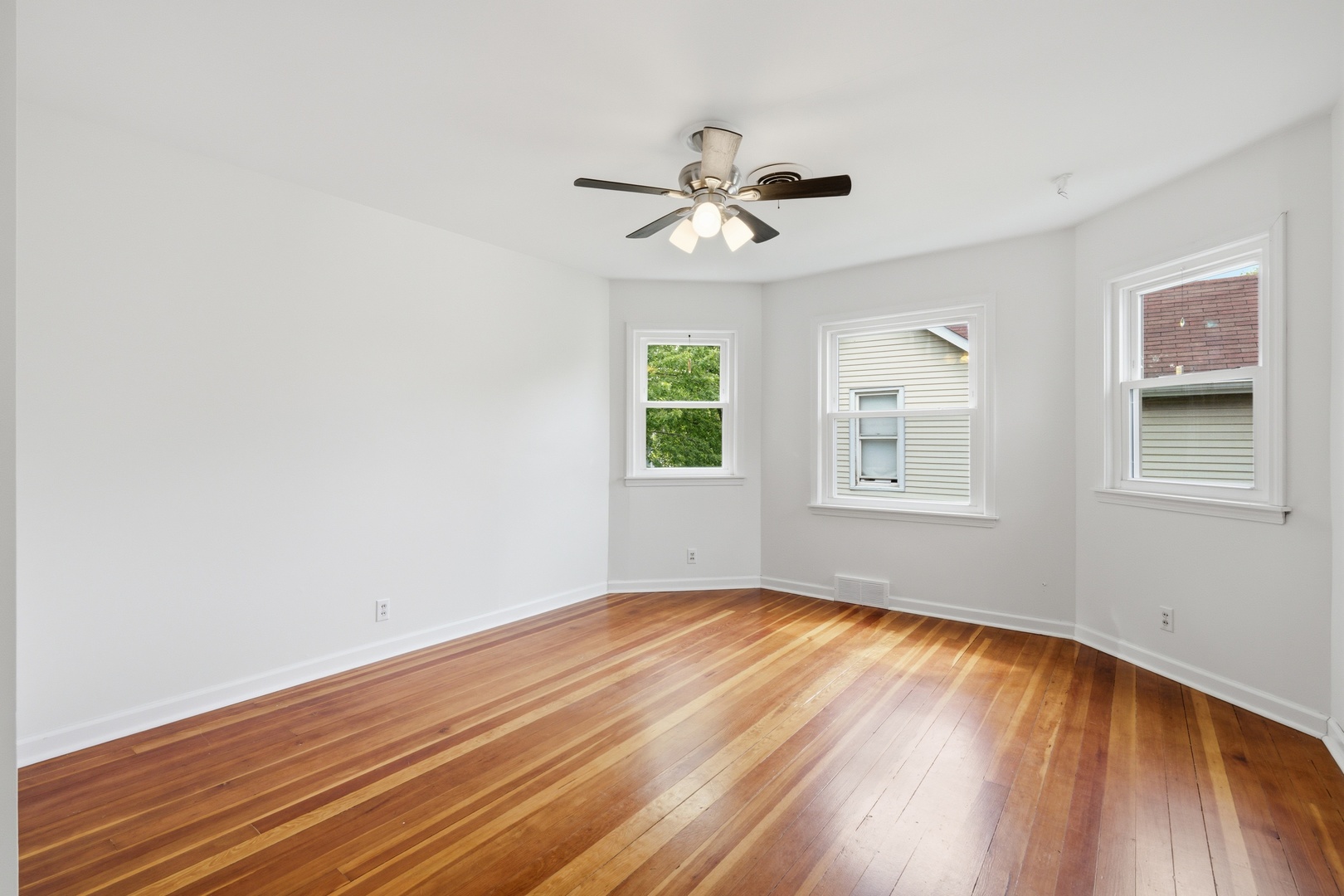 1847 10th Street Moline, IL 61265 - Photo 24 of 39 a view of empty room with wooden floor and fan