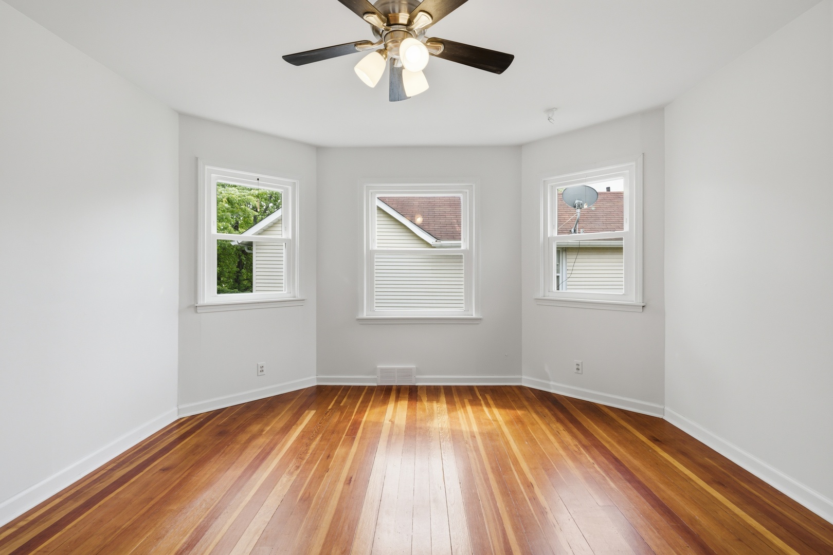 1847 10th Street Moline, IL 61265 - Photo 25 of 39 a view of empty room with wooden floor and fan