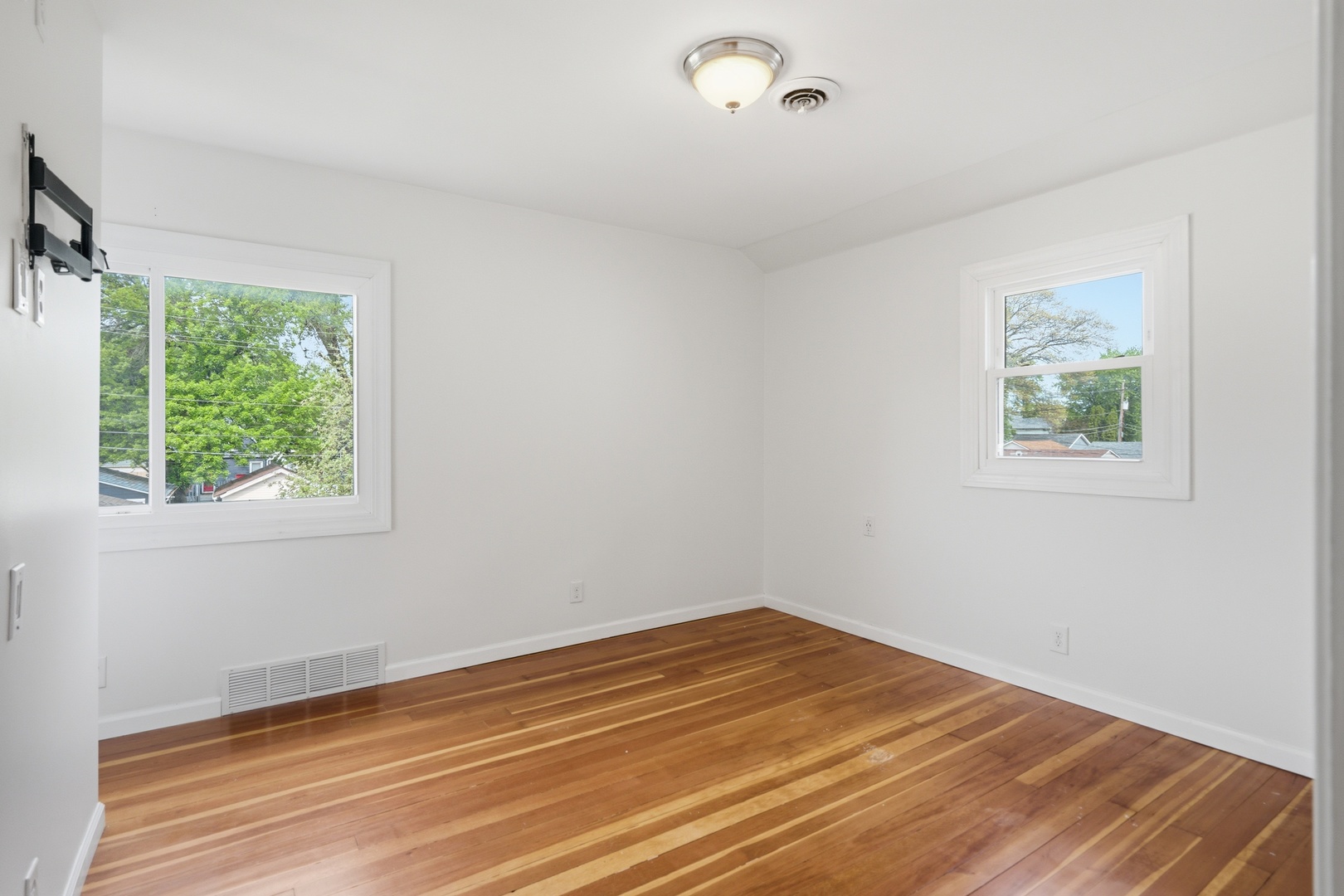1847 10th Street Moline, IL 61265 - Photo 29 of 39 a view of empty room with wooden floor and fan