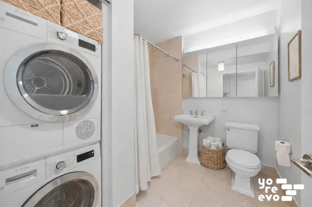 a bathroom with a toilet a sink and a mirror