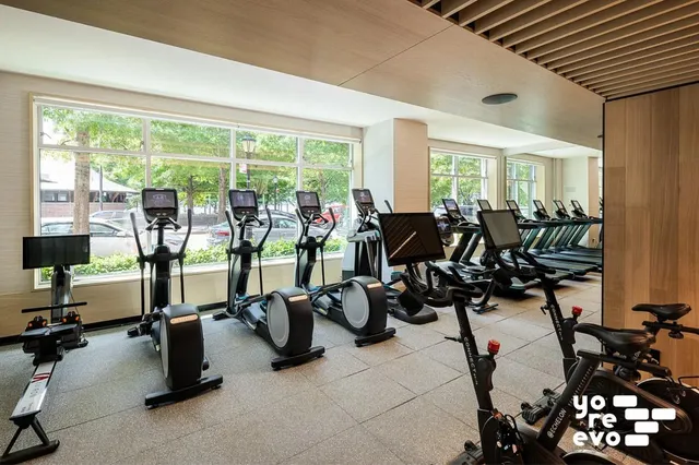 a play room with furniture and a floor to ceiling window