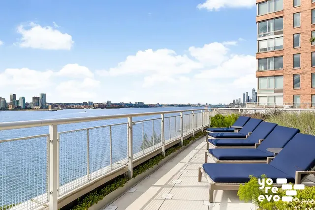 a kitchen with white cabinets and chairs
