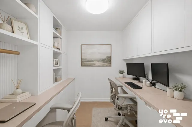 a bedroom with a bed tv and a window