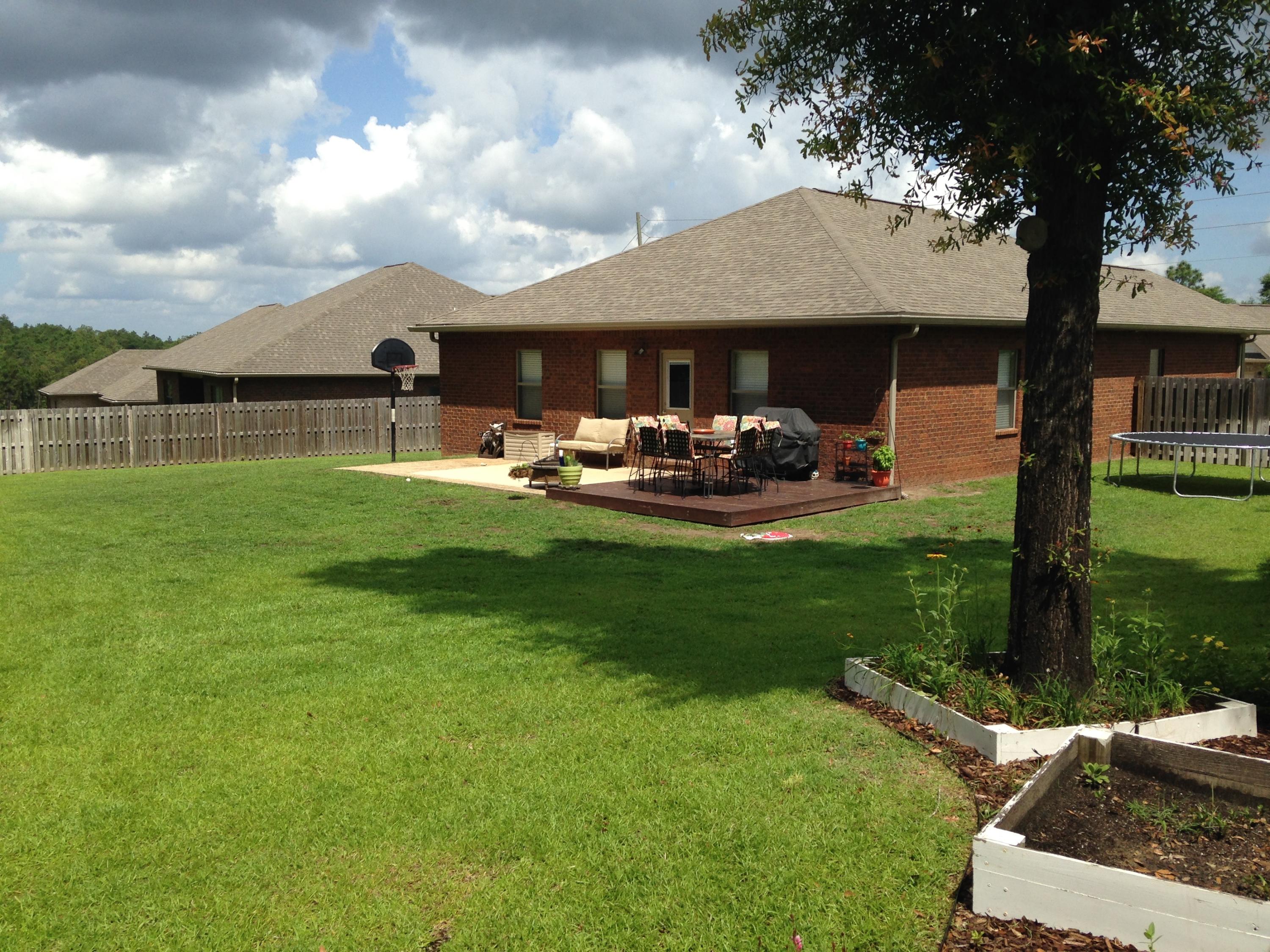 632 Red Fern Road Crestview, FL 32536 - Photo 22 of 36 a front view of a house with garden and trees
