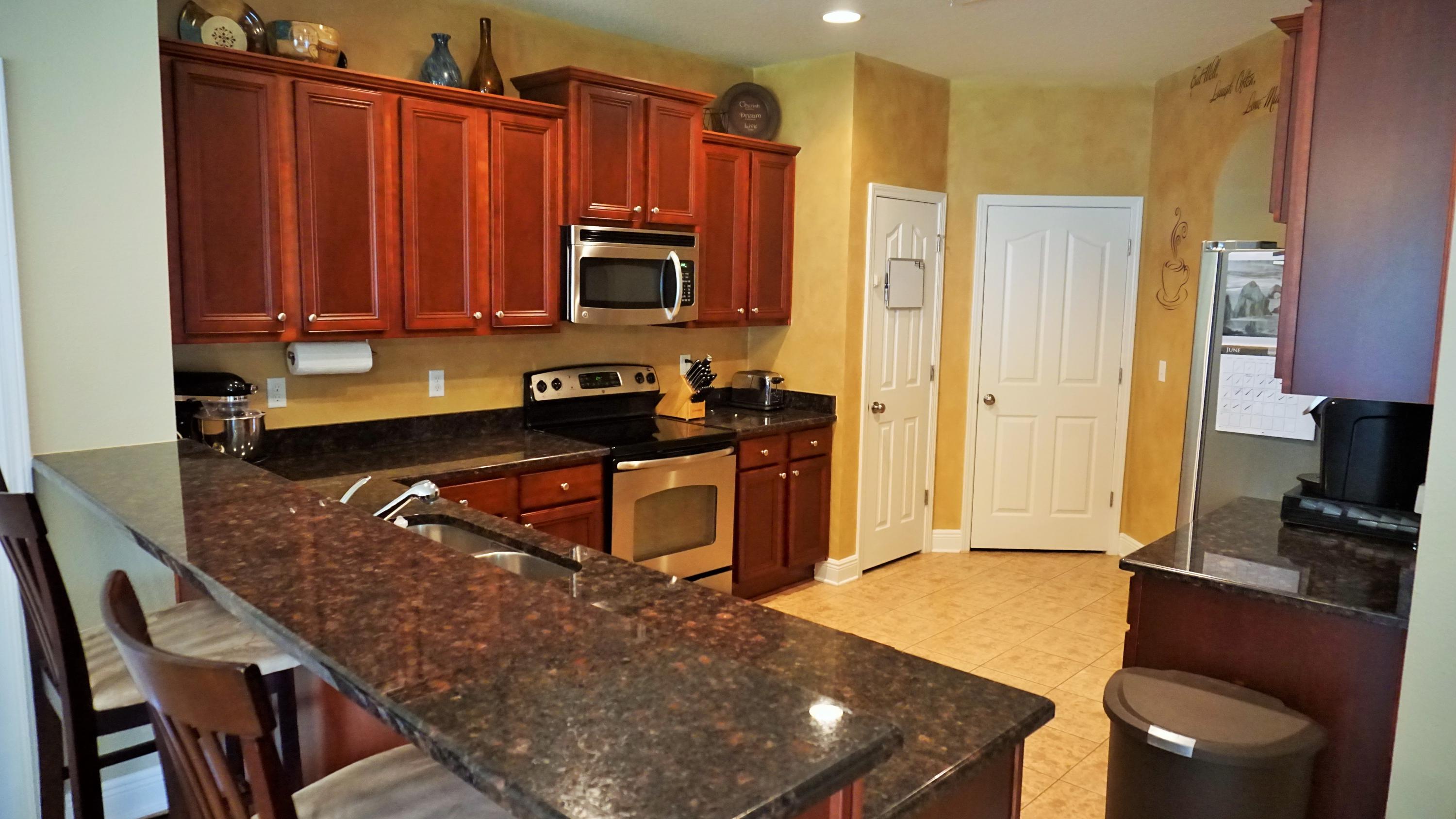 632 Red Fern Road Crestview, FL 32536 - Photo 6 of 36 a kitchen with stainless steel appliances a stove a sink a microwave a refrigerator and cabinets