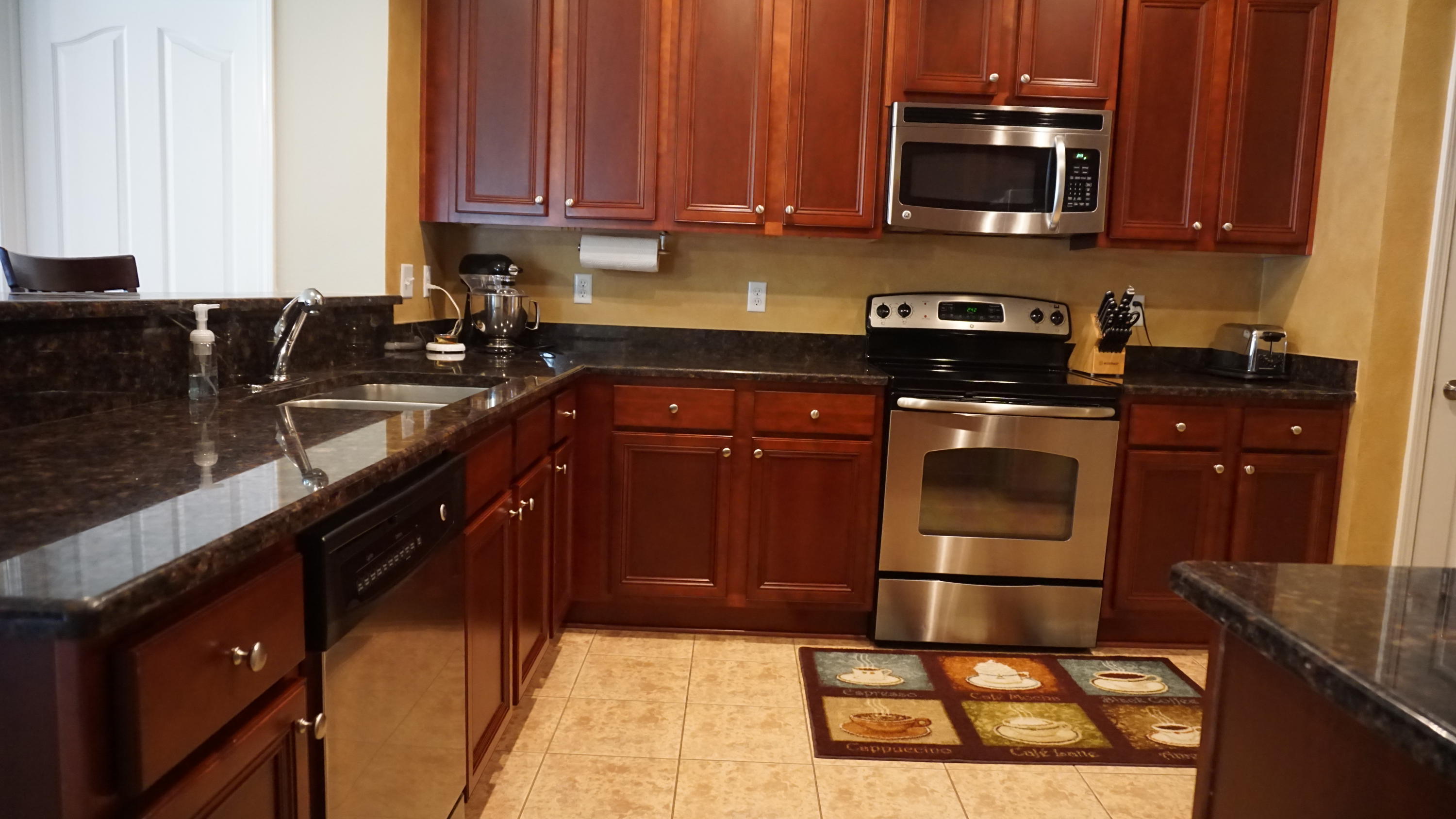 632 Red Fern Road Crestview, FL 32536 - Photo 8 of 36 a kitchen with stainless steel appliances granite countertop a stove a sink and a microwave