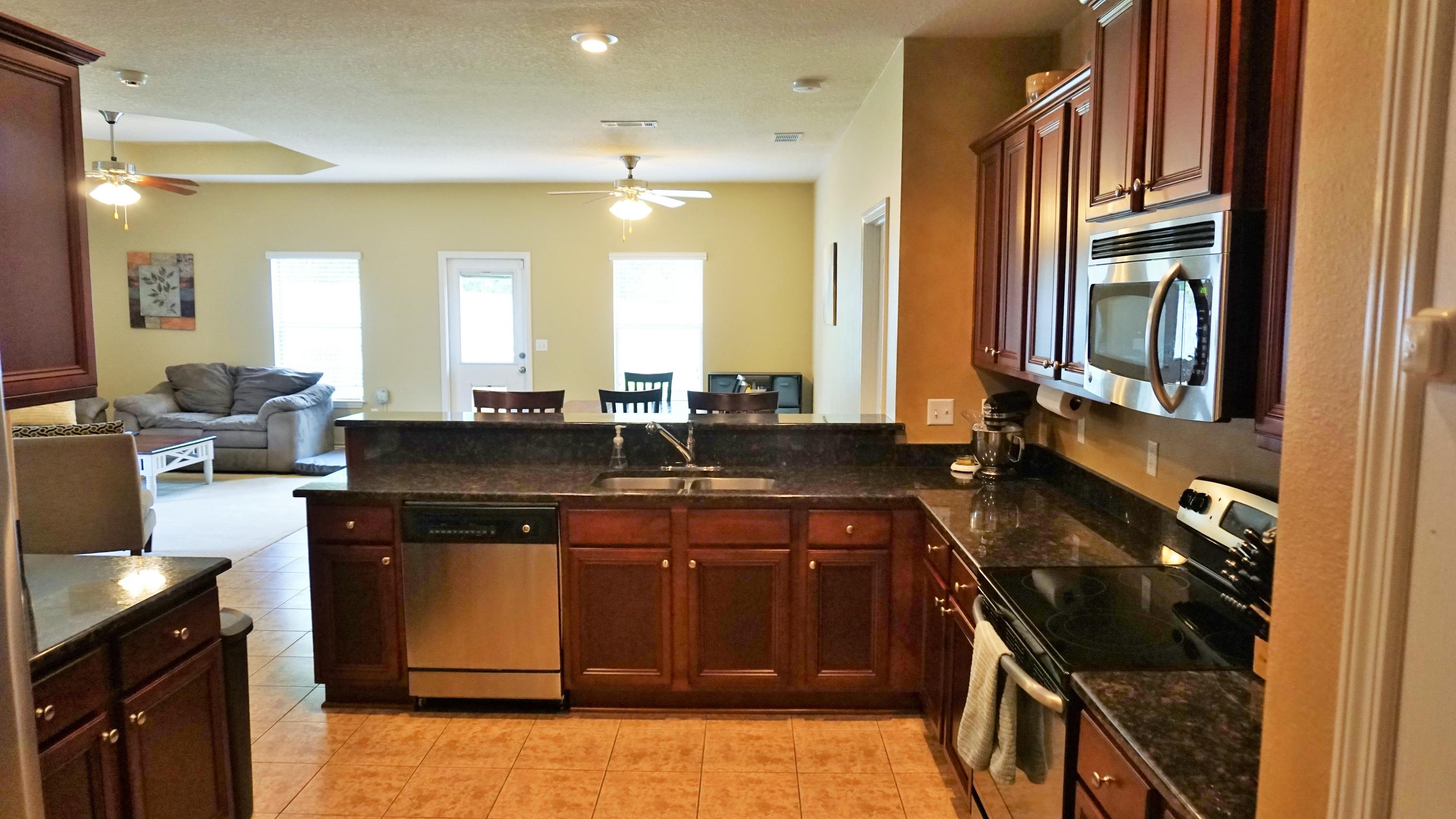 632 Red Fern Road Crestview, FL 32536 - Photo 9 of 36 a kitchen with a sink stove and cabinets