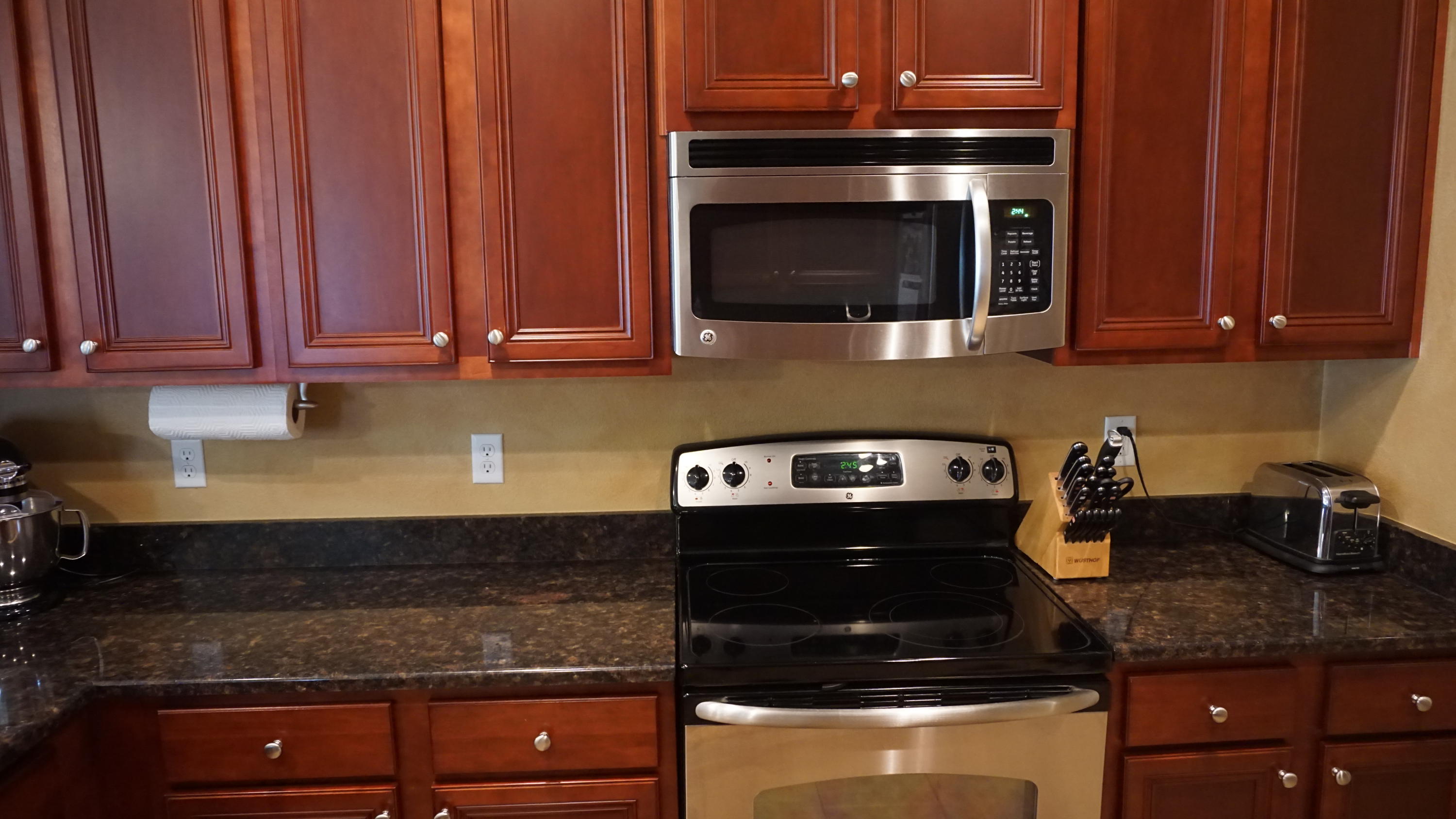 632 Red Fern Road Crestview, FL 32536 - Photo 10 of 36 a kitchen with stainless steel appliances granite countertop a stove and a microwave