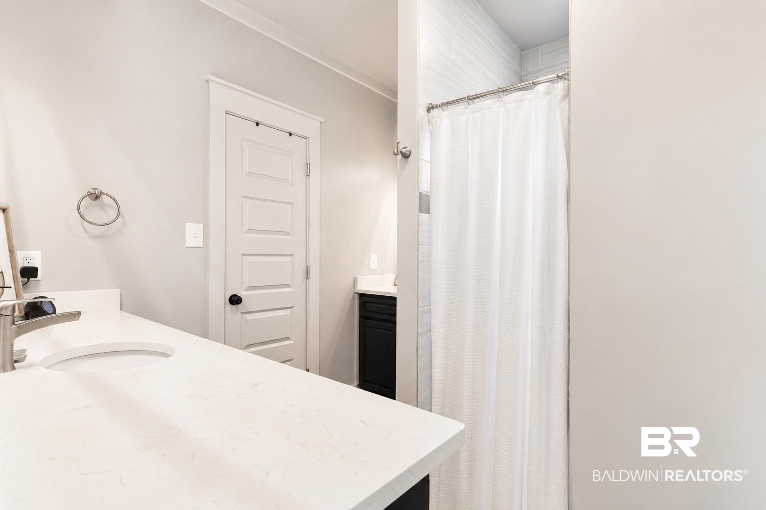 9825 Wolf Creek Ridge Elberta, AL 36530 - Photo 19 of 76 Bathroom featuring white walls, a white countertop with an integrated sink, a brushed nickel faucet, and a shower with white subway tile surround