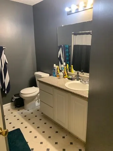 a bedroom with a bed and a chair