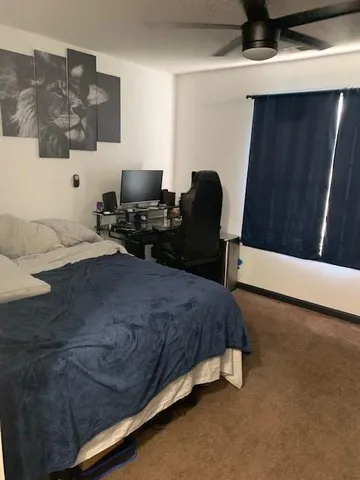 a bed room with a bed and a chair