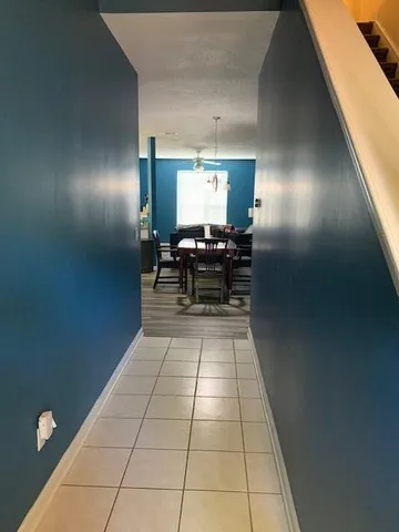 a view of a hallway with seating area