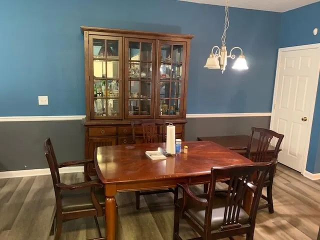a view of a dining room with furniture and chandelier