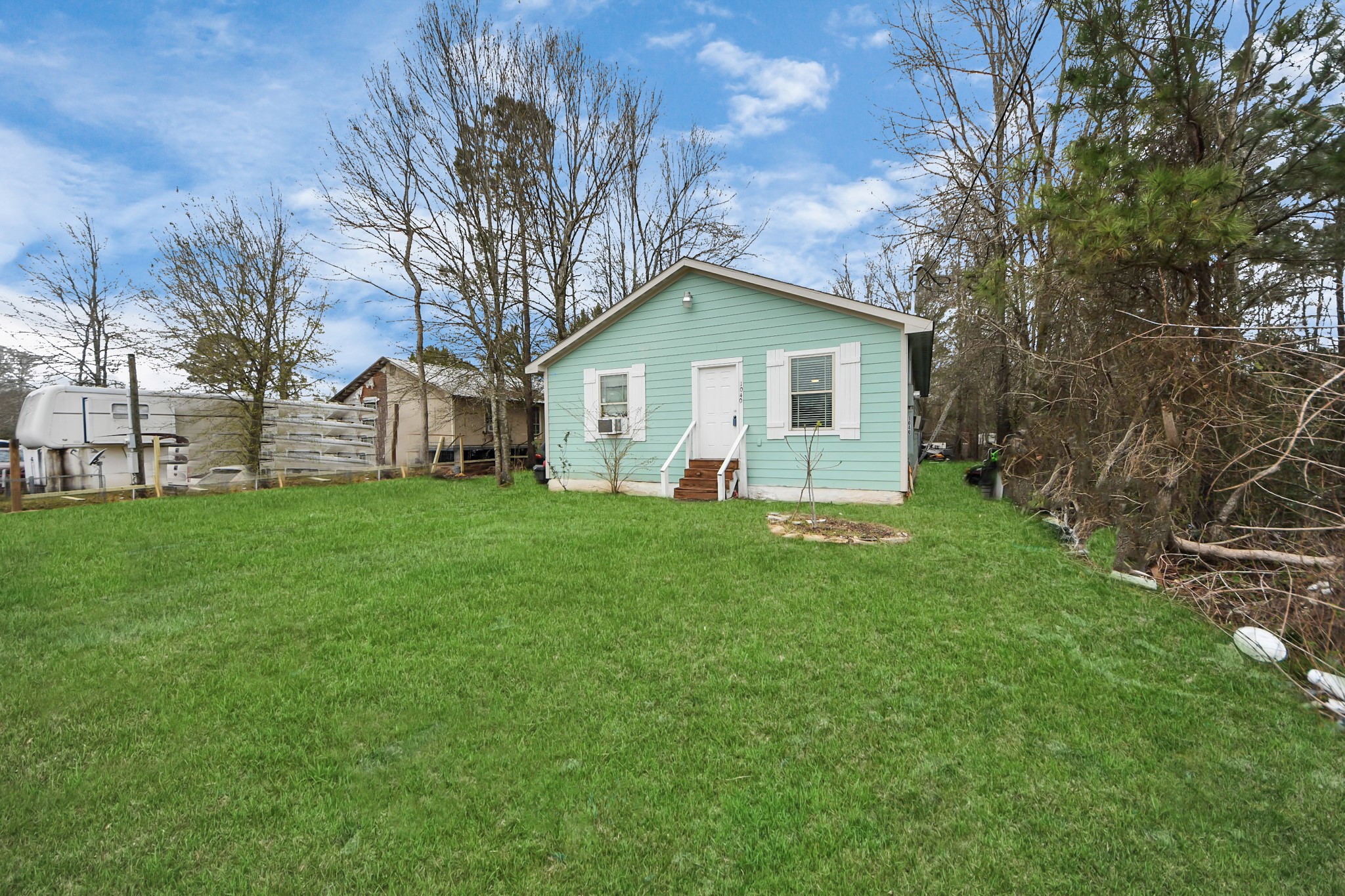1040 County Road 5007 Cleveland, TX 77327 - Photo 2 of 47 a front view of house with yard and green space