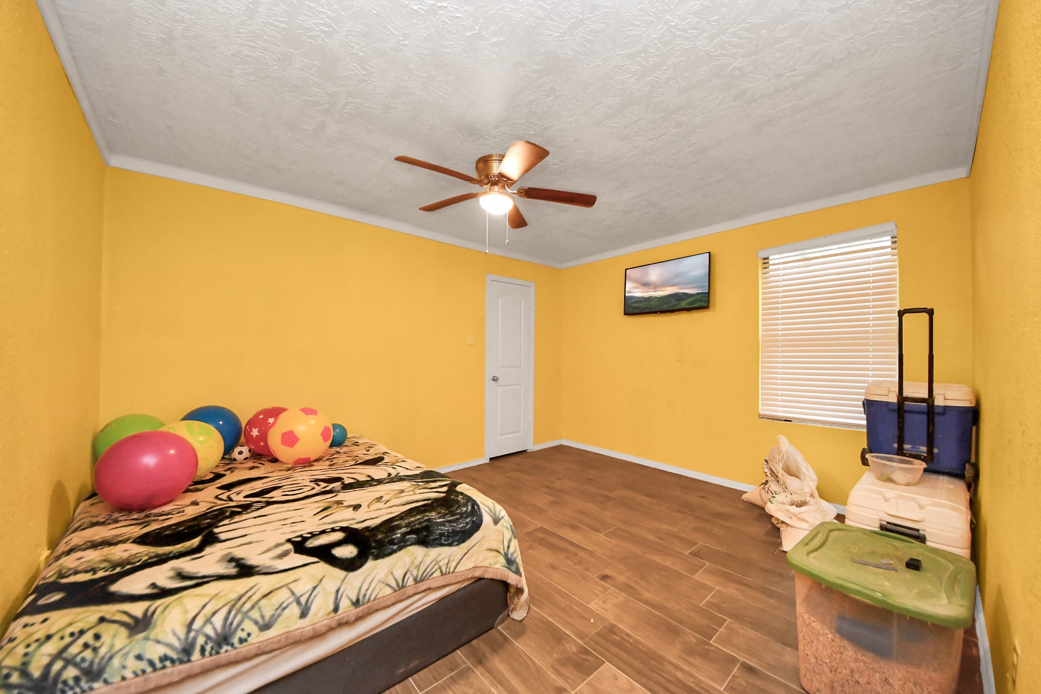 1040 County Road 5007 Cleveland, TX 77327 - Photo 21 of 47 a bedroom with a bed and a chandelier