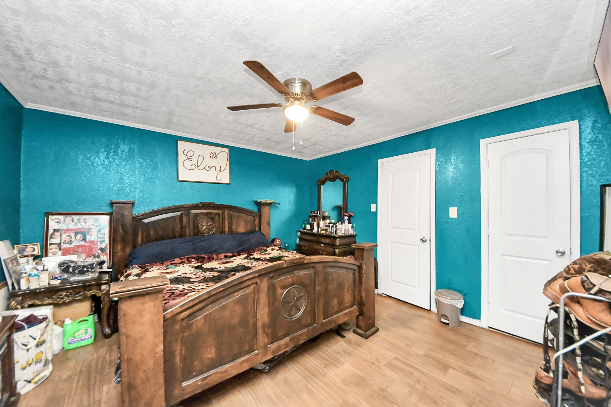 1040 County Road 5007 Cleveland, TX 77327 - Photo 24 of 47 a bedroom with a bed and a chandelier