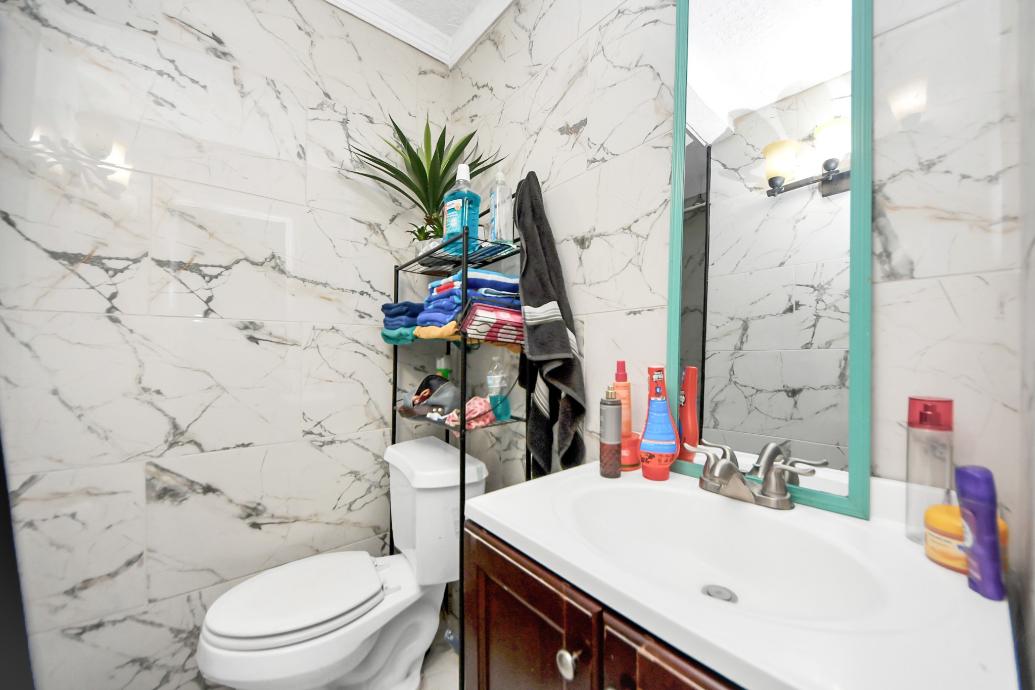 1040 County Road 5007 Cleveland, TX 77327 - Photo 27 of 47 a bathroom with a sink a toilet and shower curtain