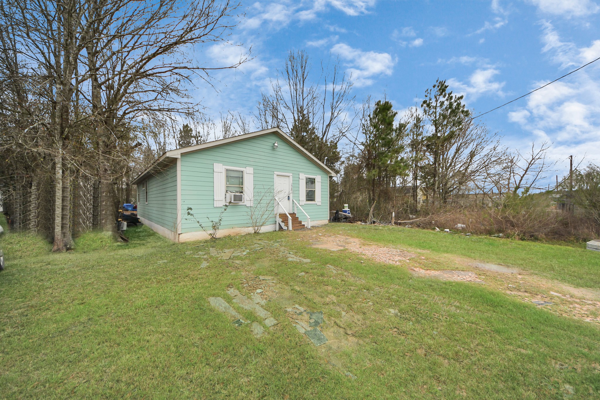 1040 County Road 5007 Cleveland, TX 77327 - Photo 29 of 47 a view of a house with a yard
