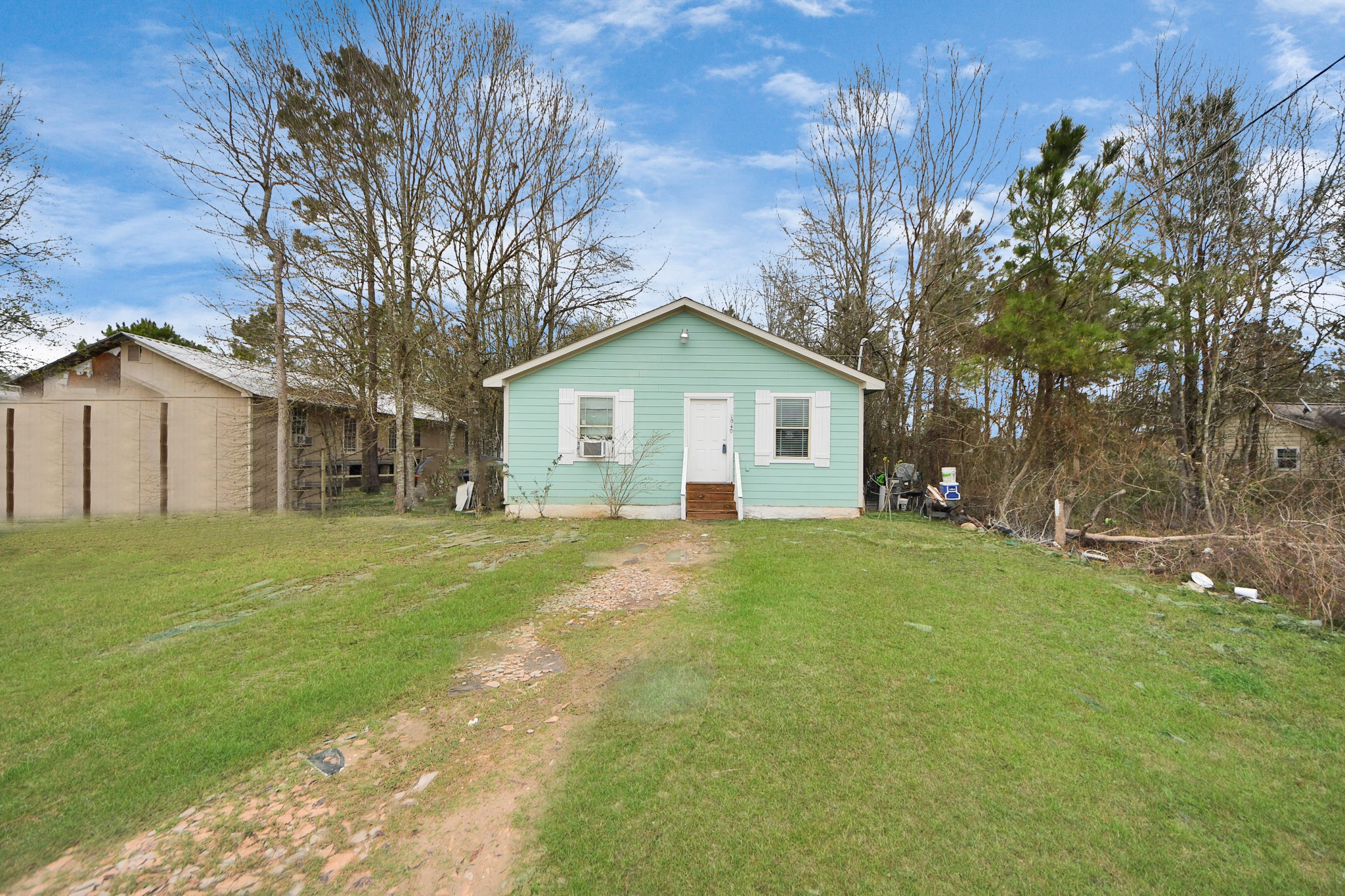 1040 County Road 5007 Cleveland, TX 77327 - Photo 31 of 47 a front view of house with yard and green space