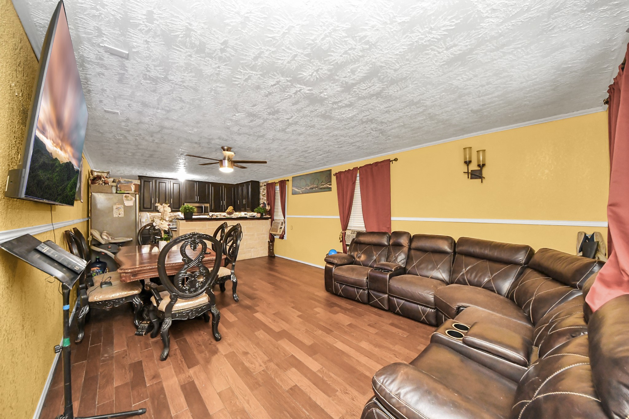 1040 County Road 5007 Cleveland, TX 77327 - Photo 5 of 47 a living room with furniture and a flat screen tv