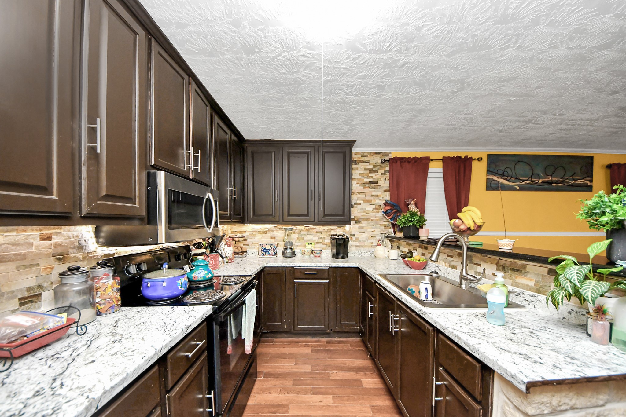 1040 County Road 5007 Cleveland, TX 77327 - Photo 10 of 47 a kitchen with stainless steel appliances granite countertop a sink stove and cabinets