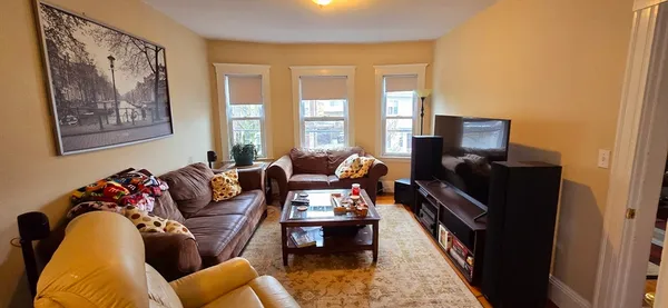 a living room with furniture fireplace and a flat screen tv