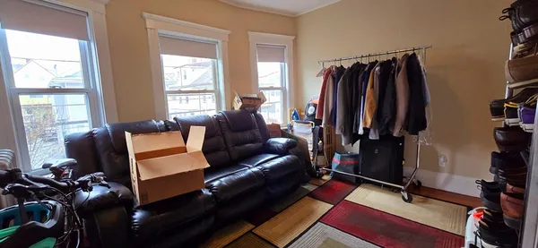 a living room with furniture a air conditioner and a window