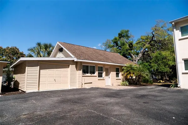 a view of a house with a yard and garage