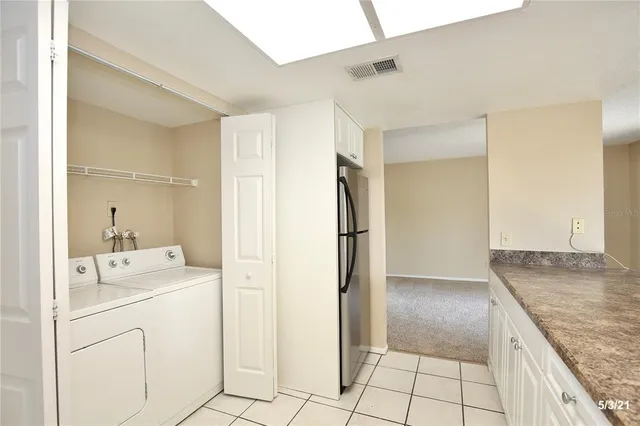 a kitchen with a refrigerator sink and cabinets