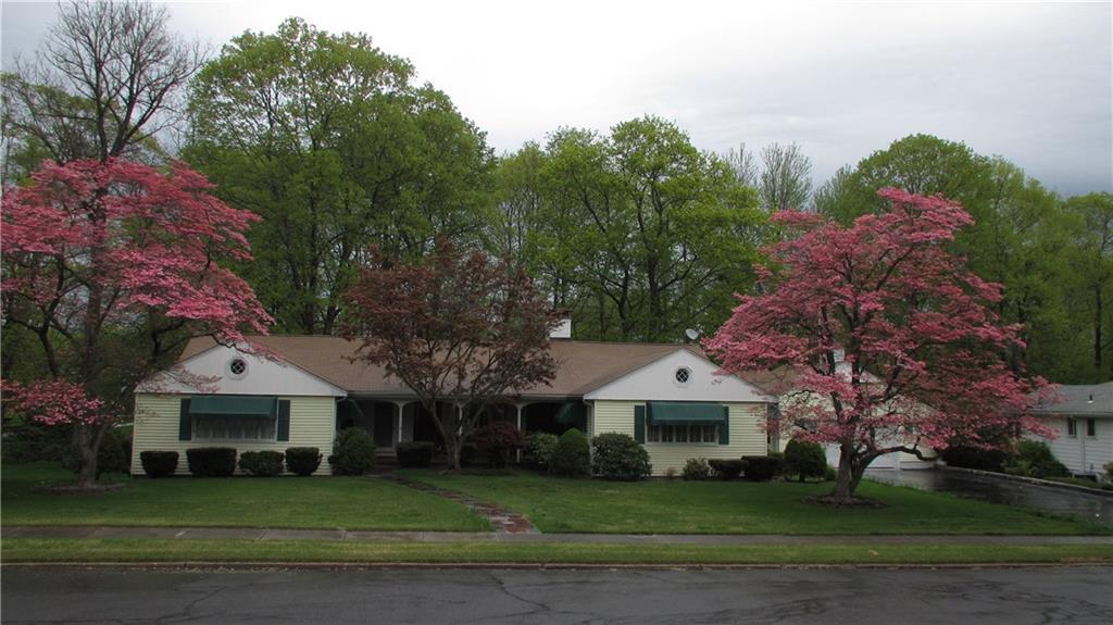 a front view of a house with a garden