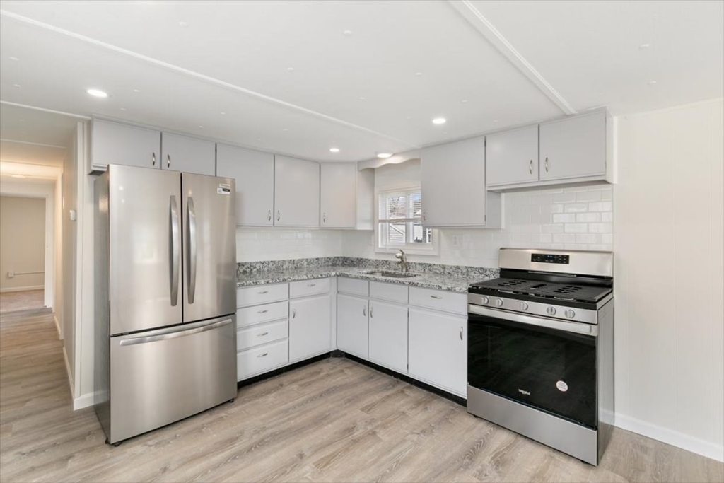 5 E Street Merrimac, MA 01860 - Photo 11 of 25 a kitchen with a stove refrigerator and a sink