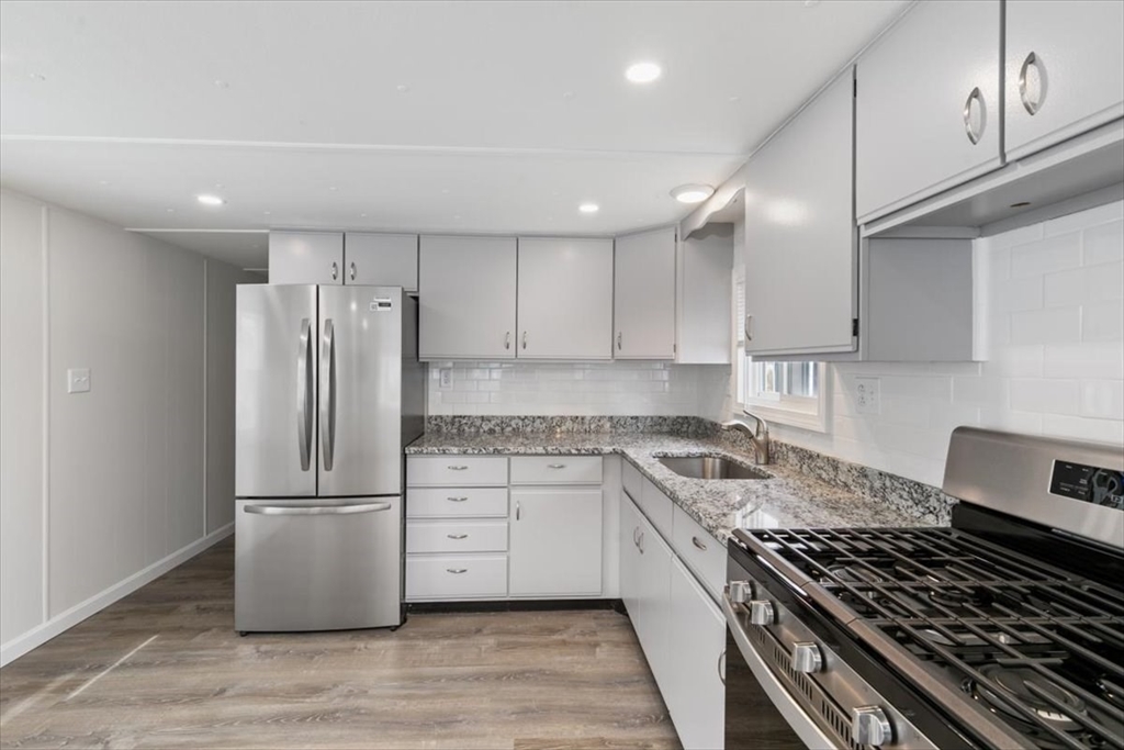 5 E Street Merrimac, MA 01860 - Photo 12 of 25 a kitchen with granite countertop a stove sink and refrigerator