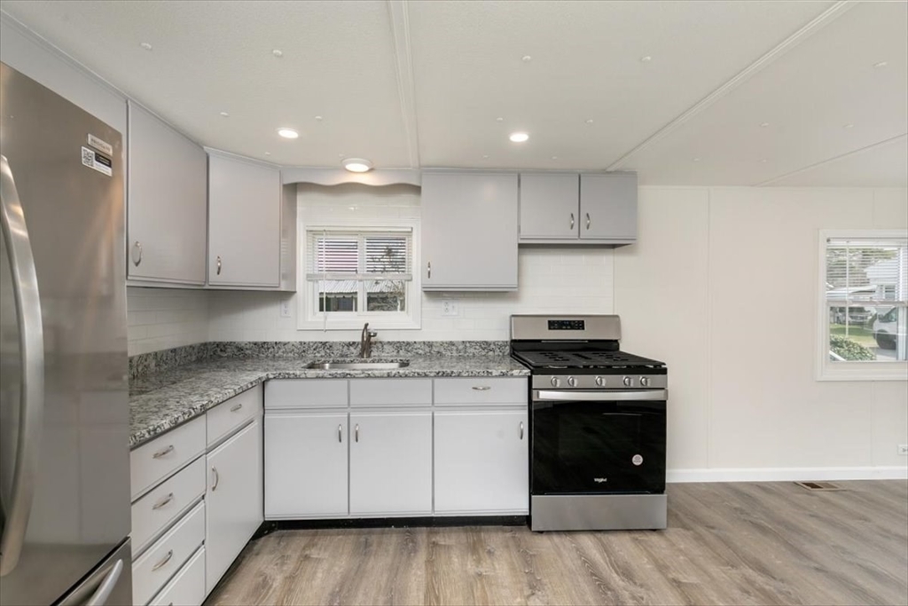 5 E Street Merrimac, MA 01860 - Photo 13 of 25 a kitchen with stainless steel appliances granite countertop a stove and a sink