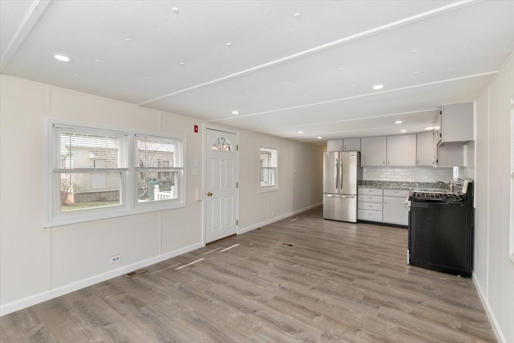 5 E Street Merrimac, MA 01860 - Photo 8 of 25 a view of kitchen with wooden floor and windows