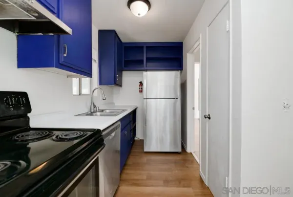a kitchen with a stove and a refrigerator
