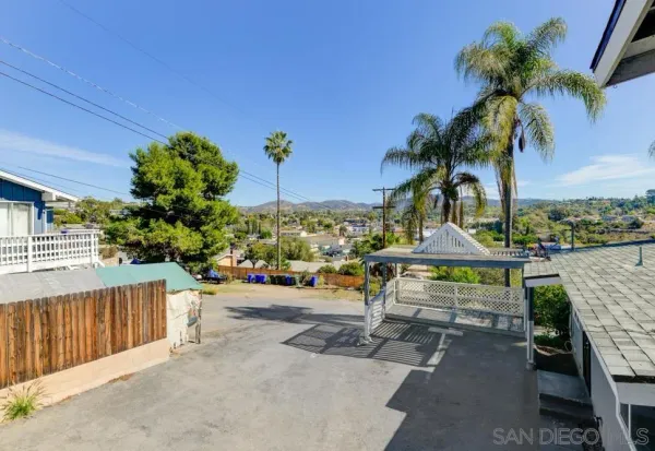 a view of a backyard and a tree