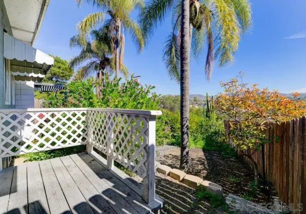 a view of a yard with wooden fence