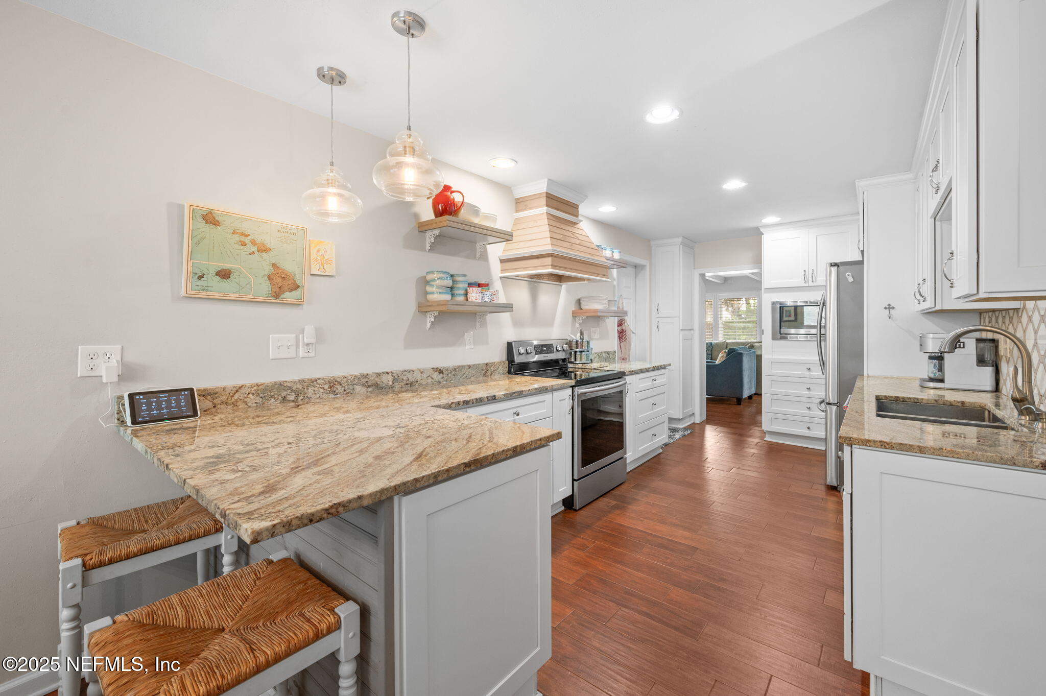 5454 2nd Street St. Augustine, FL 32080 - Photo 12 of 58 a open kitchen with stainless steel appliances granite countertop a sink dishwasher and a stove with wooden floor