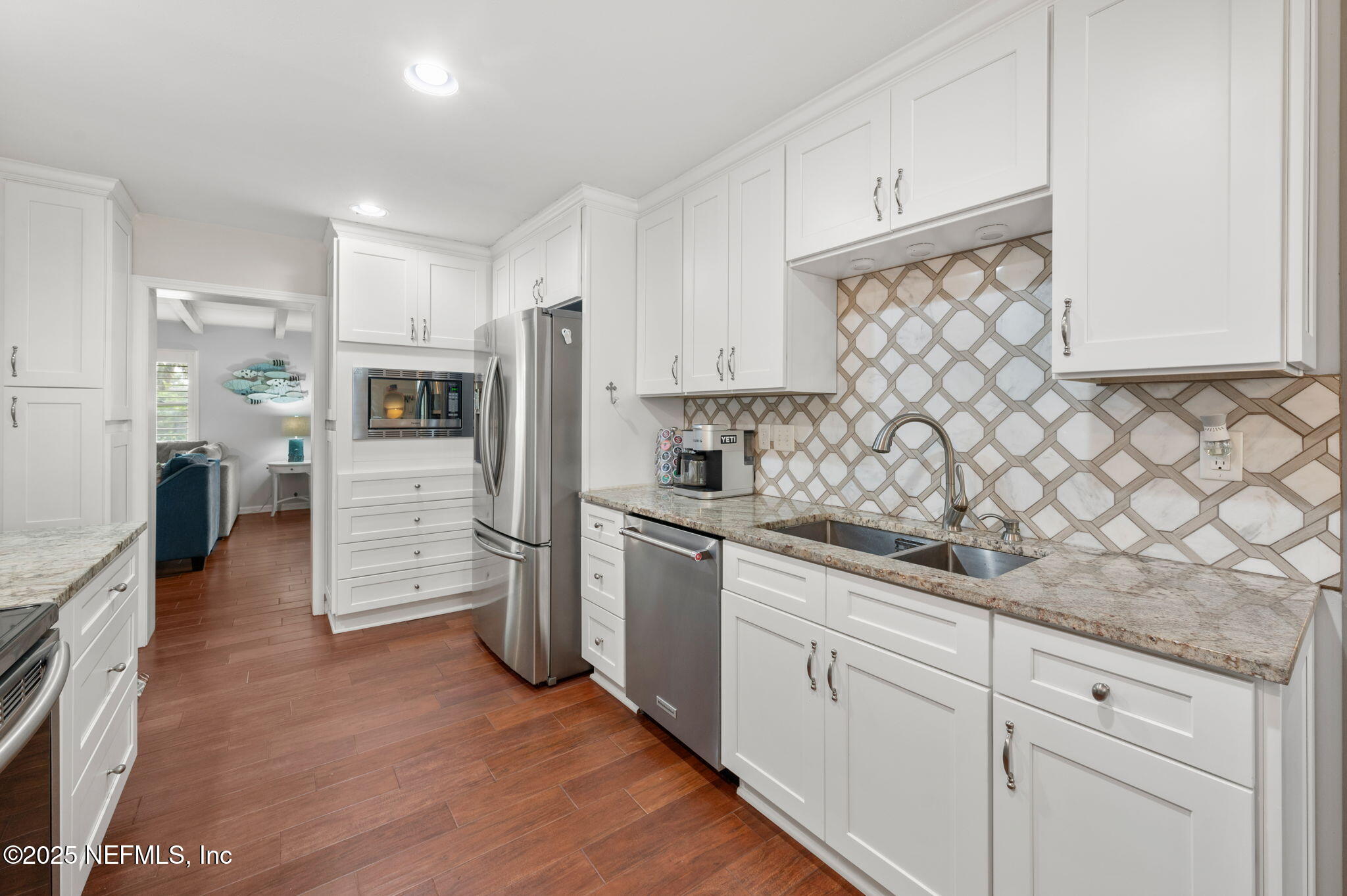 5454 2nd Street St. Augustine, FL 32080 - Photo 13 of 58 a kitchen with stainless steel appliances white cabinets and a refrigerator