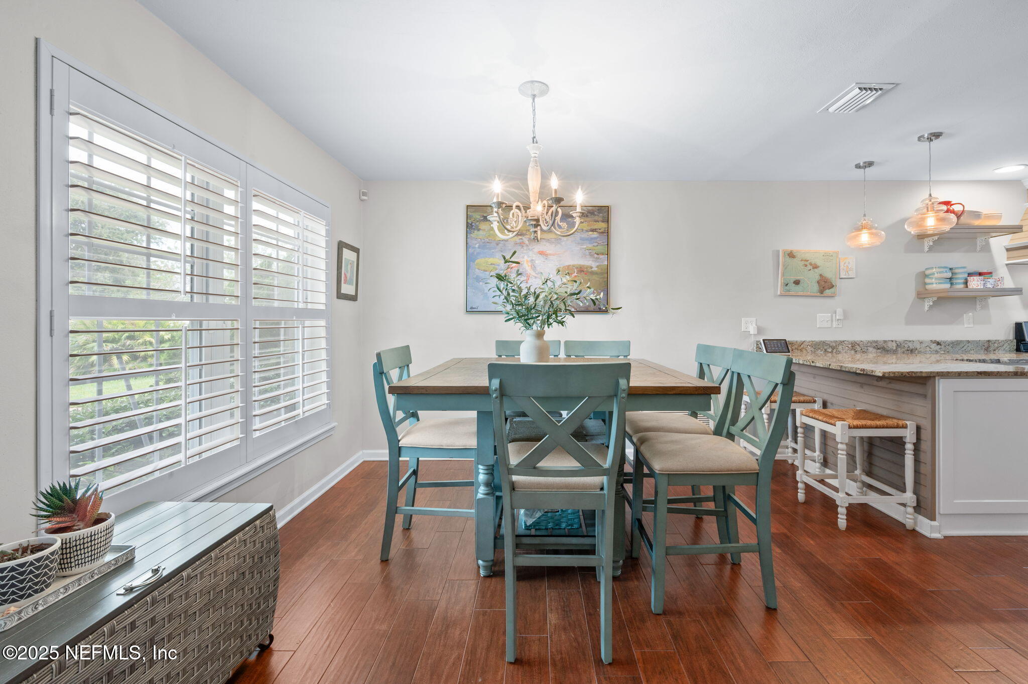 5454 2nd Street St. Augustine, FL 32080 - Photo 17 of 58 a dining room with furniture a chandelier and wooden floor