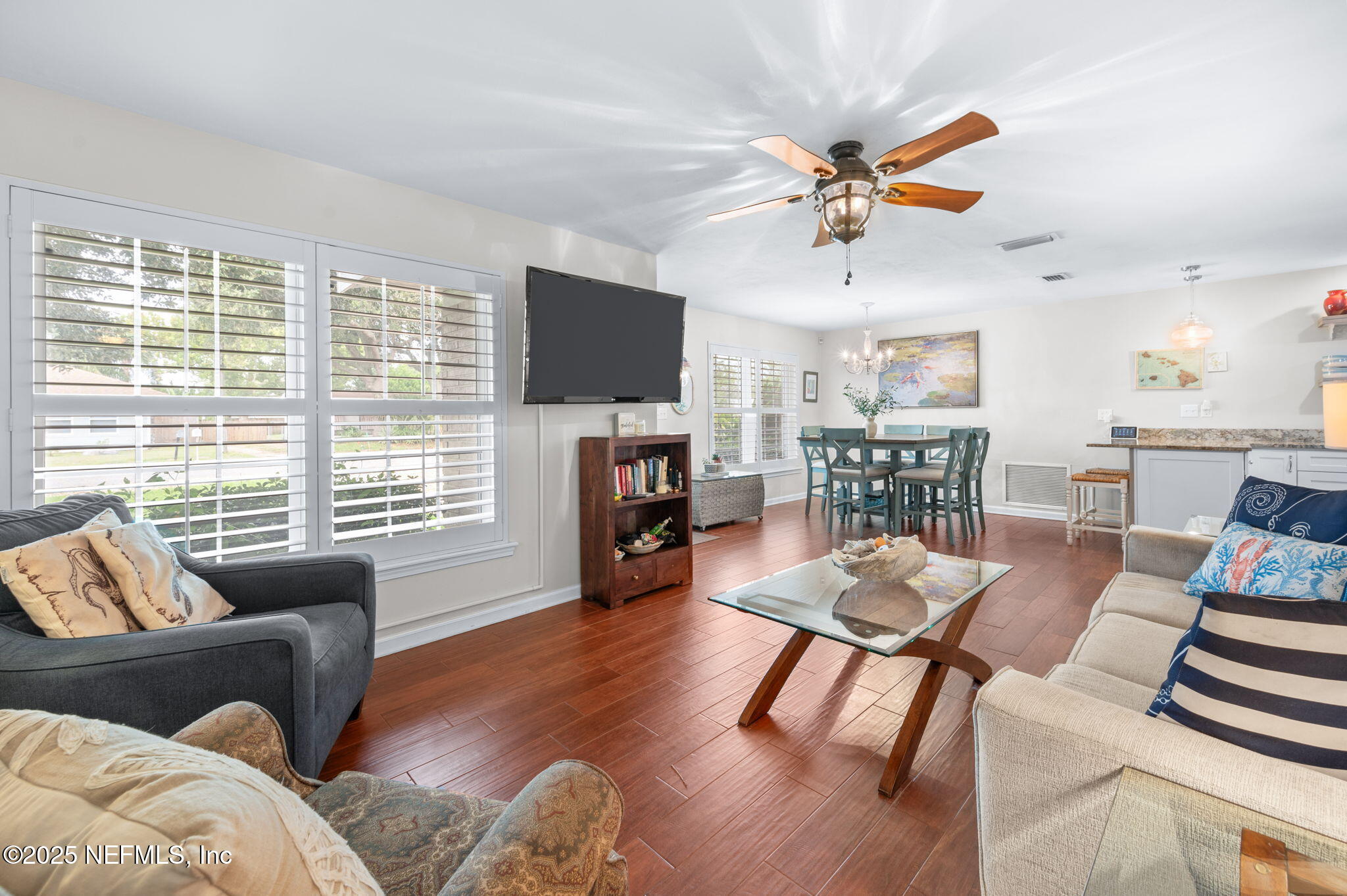 5454 2nd Street St. Augustine, FL 32080 - Photo 18 of 58 a living room with furniture a fireplace and a flat screen tv