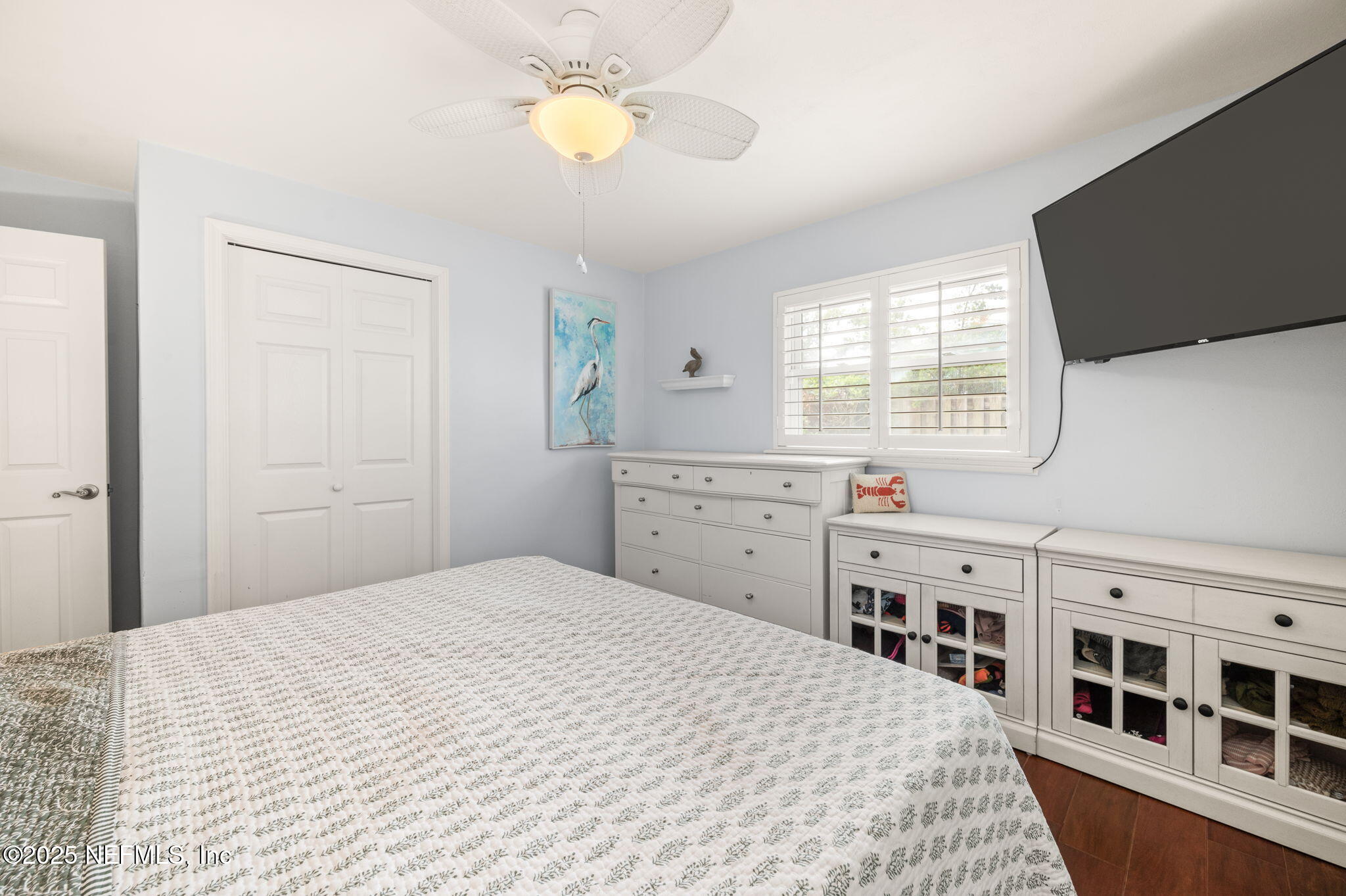 5454 2nd Street St. Augustine, FL 32080 - Photo 22 of 58 a bedroom with a bed and a flat tv screen on dresser