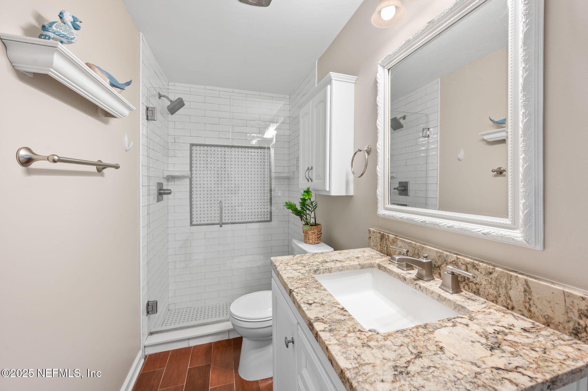 5454 2nd Street St. Augustine, FL 32080 - Photo 23 of 58 a bathroom with a granite countertop sink toilet and shower