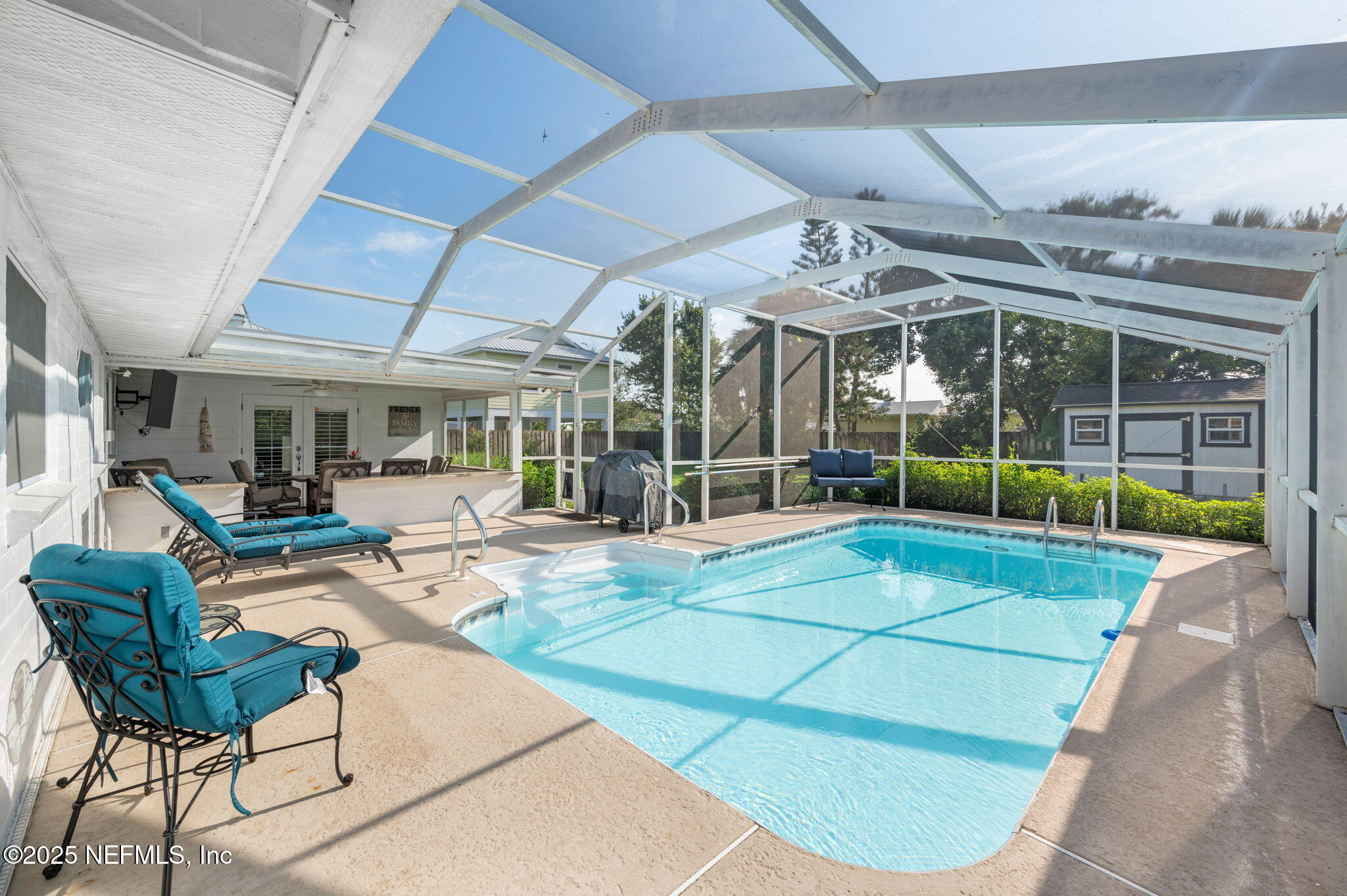 5454 2nd Street St. Augustine, FL 32080 - Photo 40 of 58 a view of a patio with a table and chairs under an umbrella