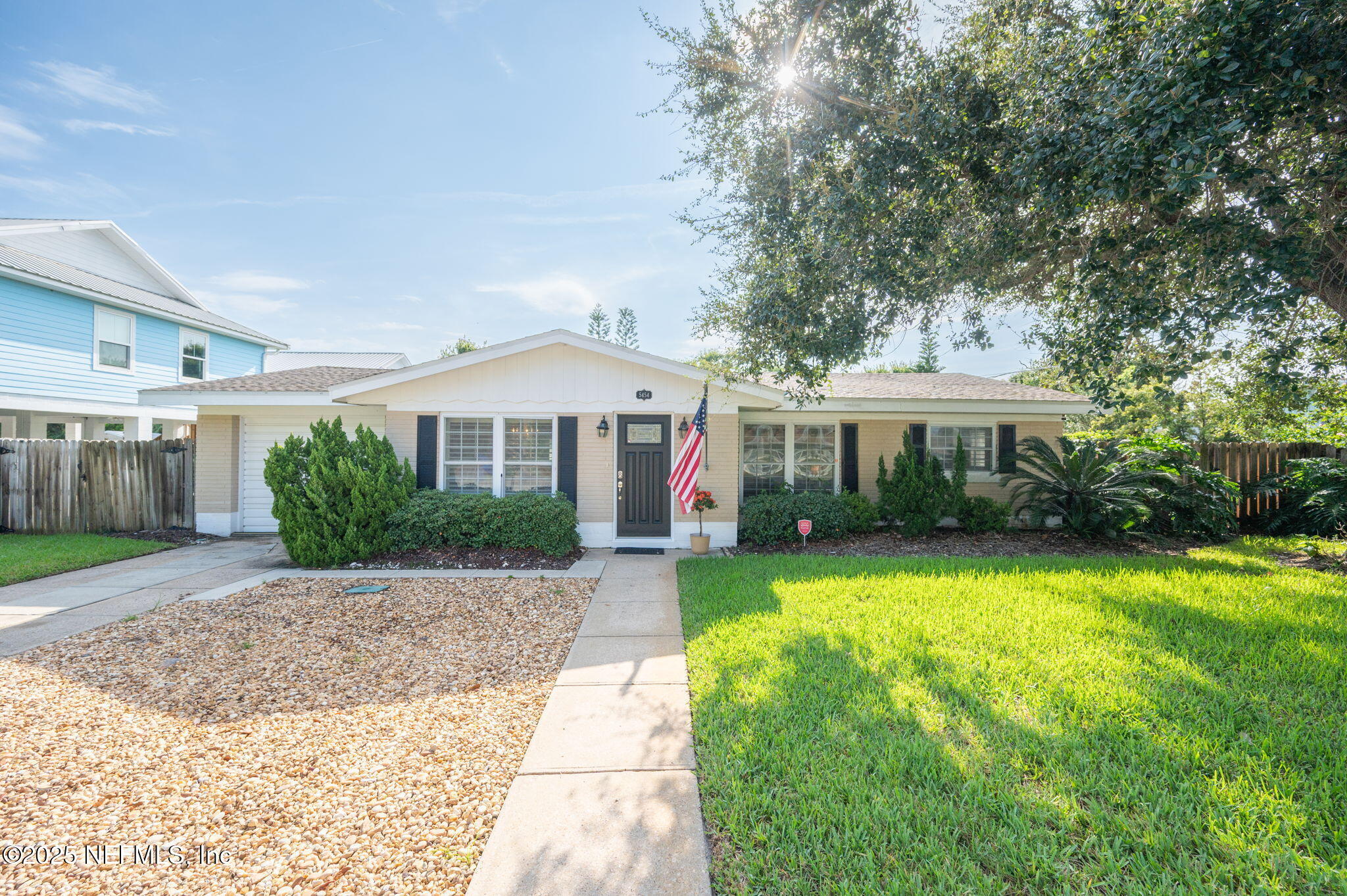 5454 2nd Street St. Augustine, FL 32080 - Photo 52 of 58 a front view of a house with a yard and garage