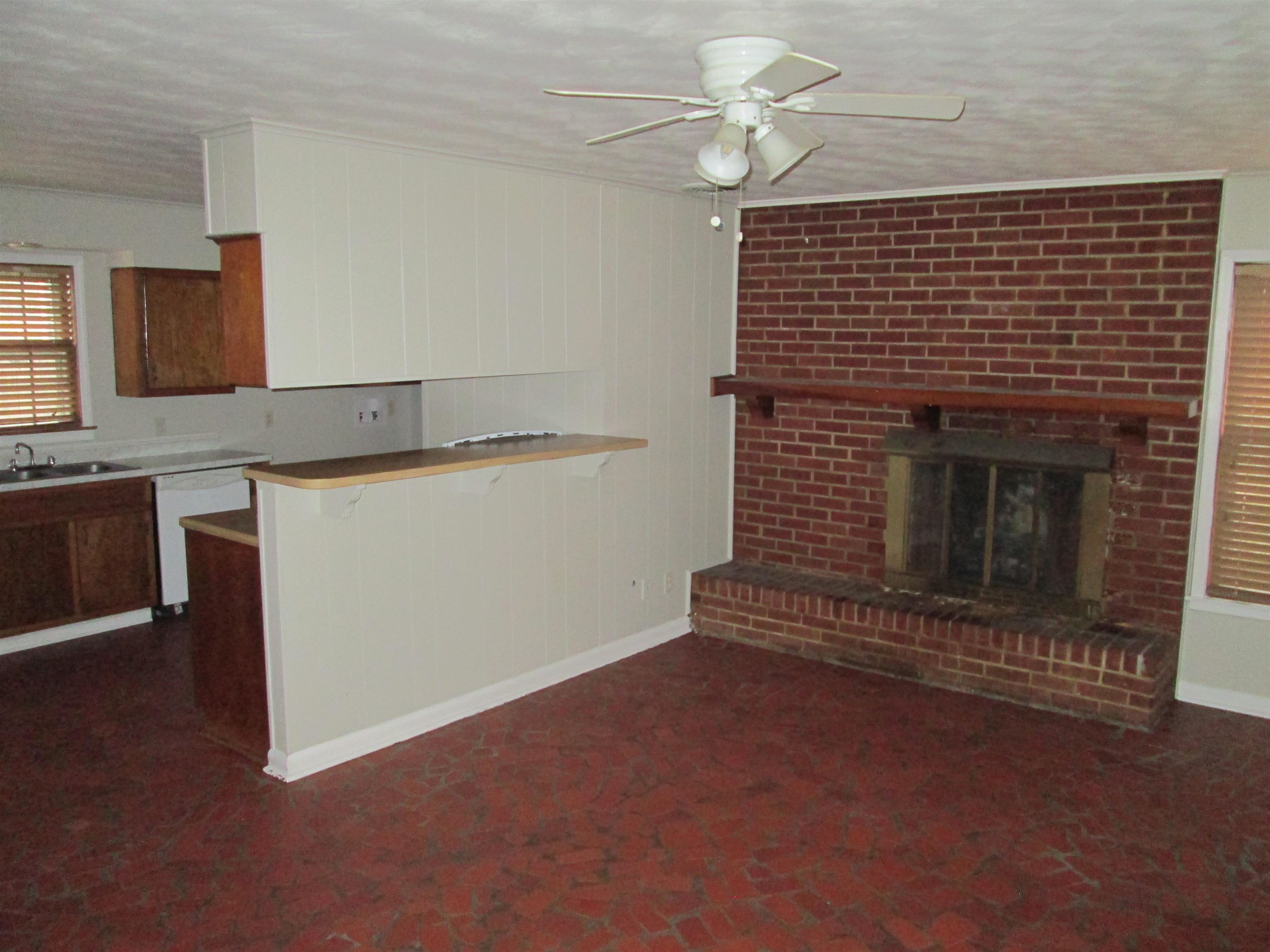 4616 Dunn Road Memphis, TN 38117 - Photo 7 of 20 a view of an empty room with a fireplace and a window