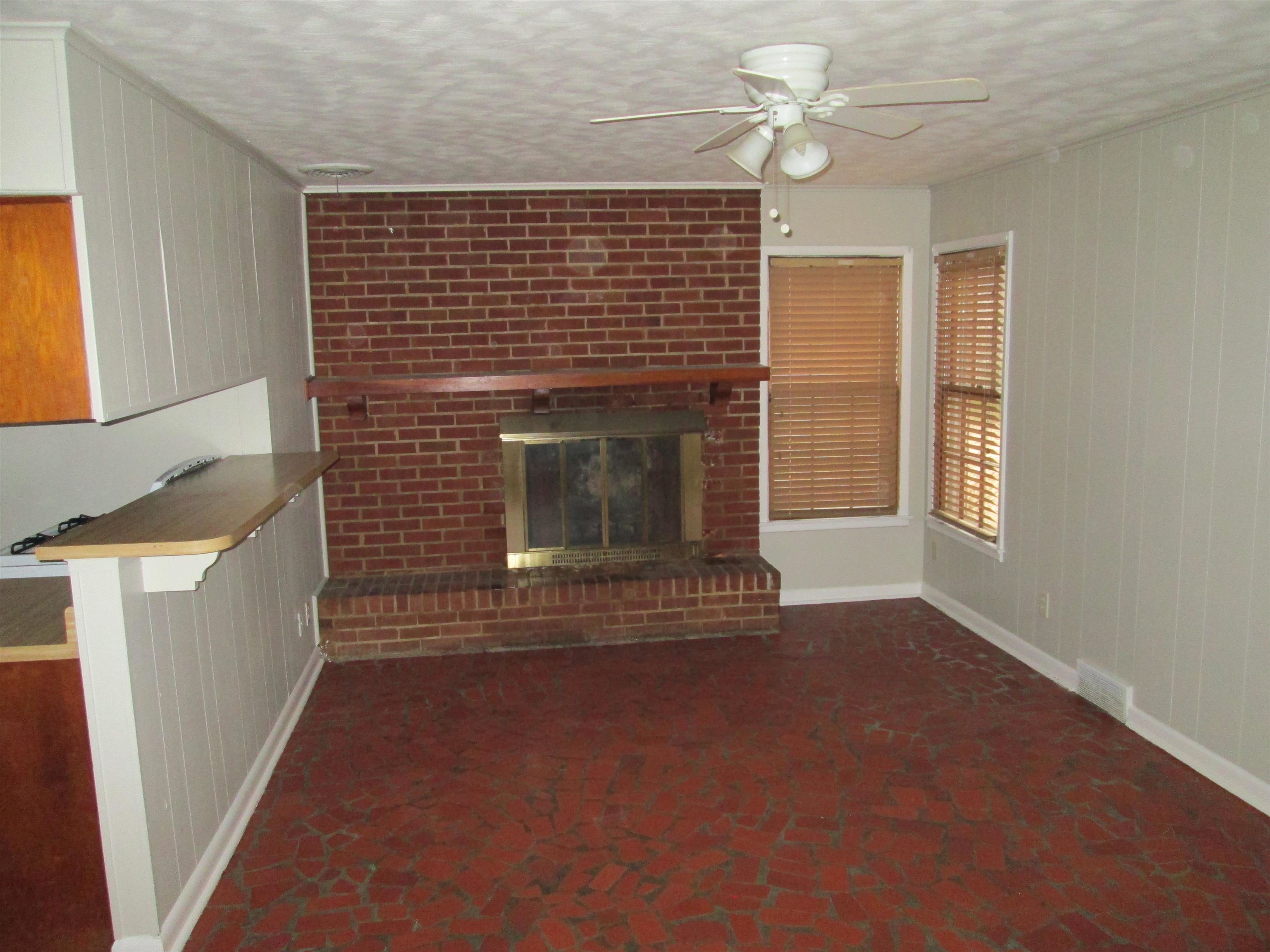 4616 Dunn Road Memphis, TN 38117 - Photo 8 of 20 a view of empty room with fireplace and fan
